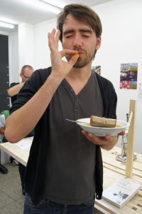 the image shows a participant enjoying the food cooked on the multipurpose furniture